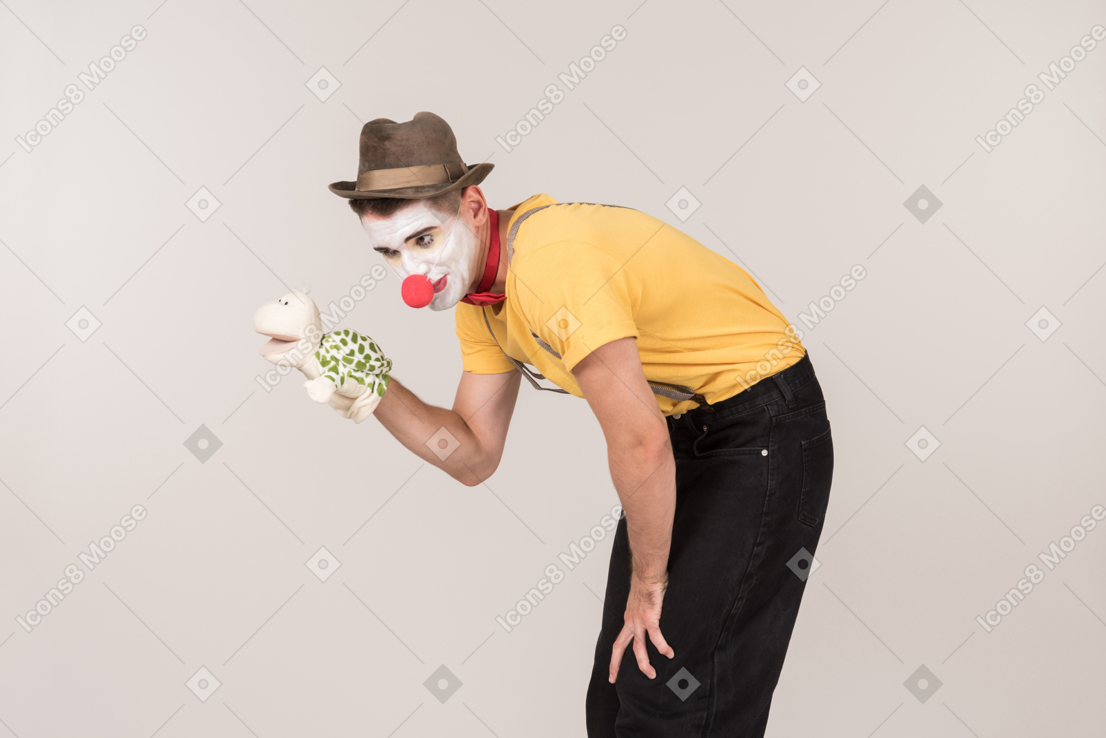 Bend male clown holding toy turtle