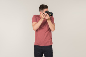 Young guy taking photos with a camera