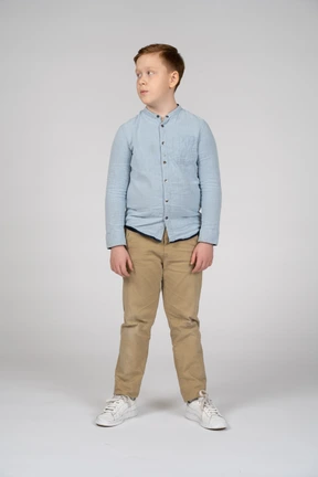 Front view of boy in casual clothes looking aside