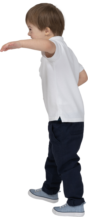 Three-quarter back view of a boy raising hand in a half-hug