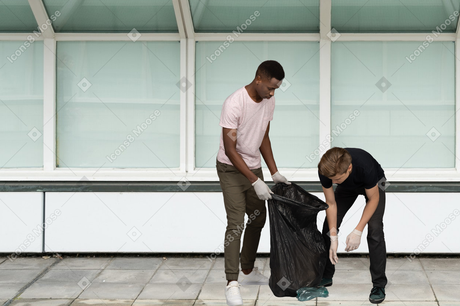 Men picking up a trash in bag