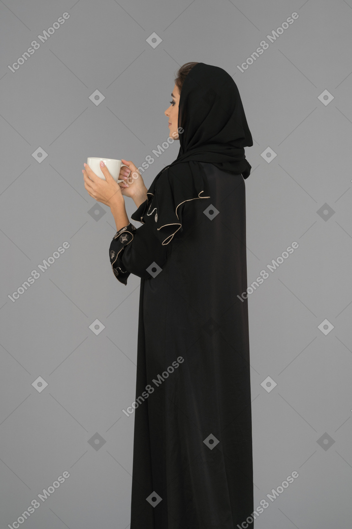 Young muslim woman holding a cup