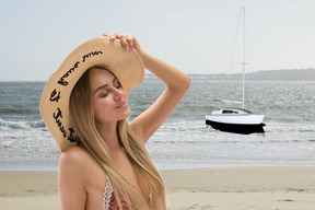 A woman wearing a hat on the beach