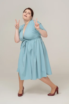 Front view of a woman in blue dress showing v signs