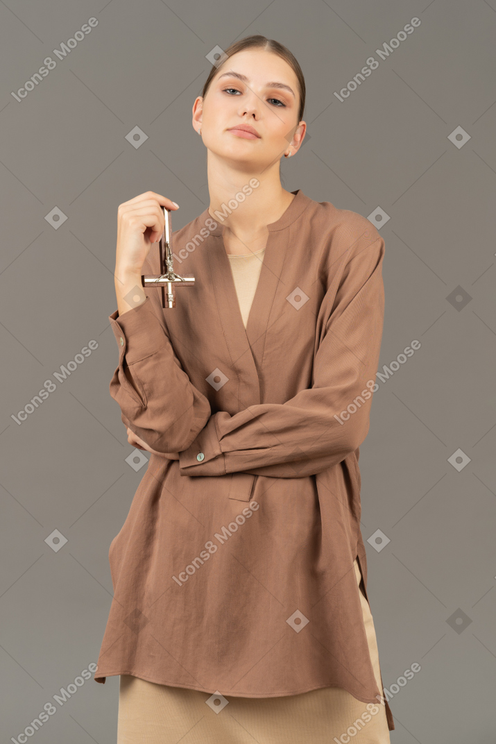Young woman looking at camera with upside down cross