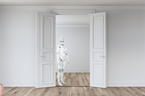 White robot standing in front of an open door