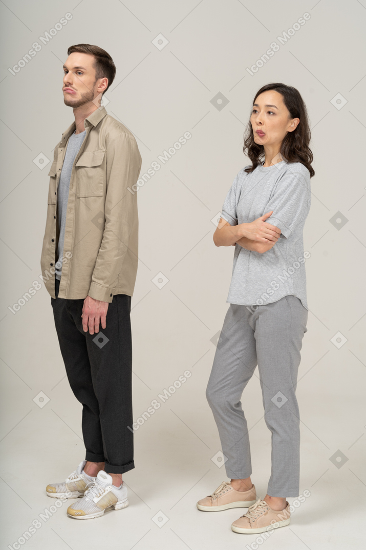 Three-quarter view of young couple pouting