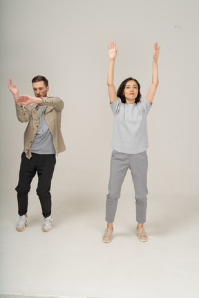 Young man and woman waving hands