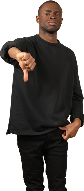Front view of young guy showing thumb down