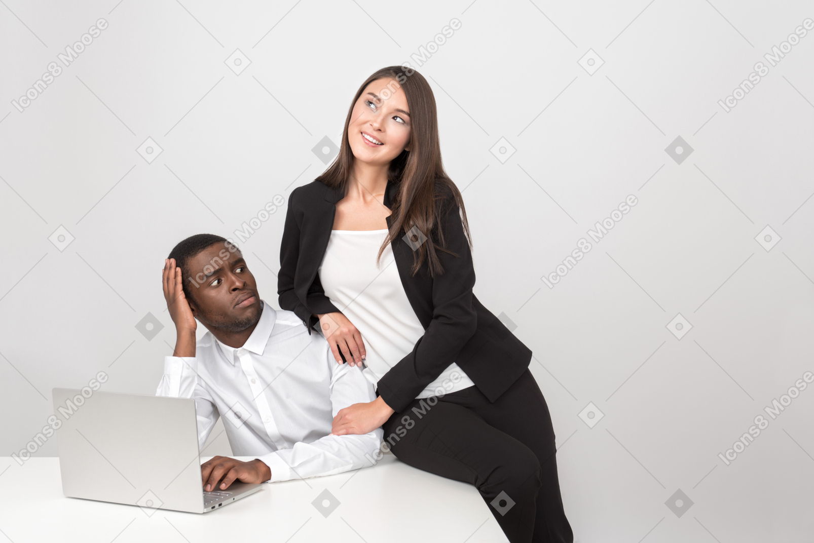 Attractive asian woman hugging her amazed collegue in the workplace