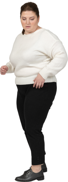 Plus size woman in casual clothes looking down