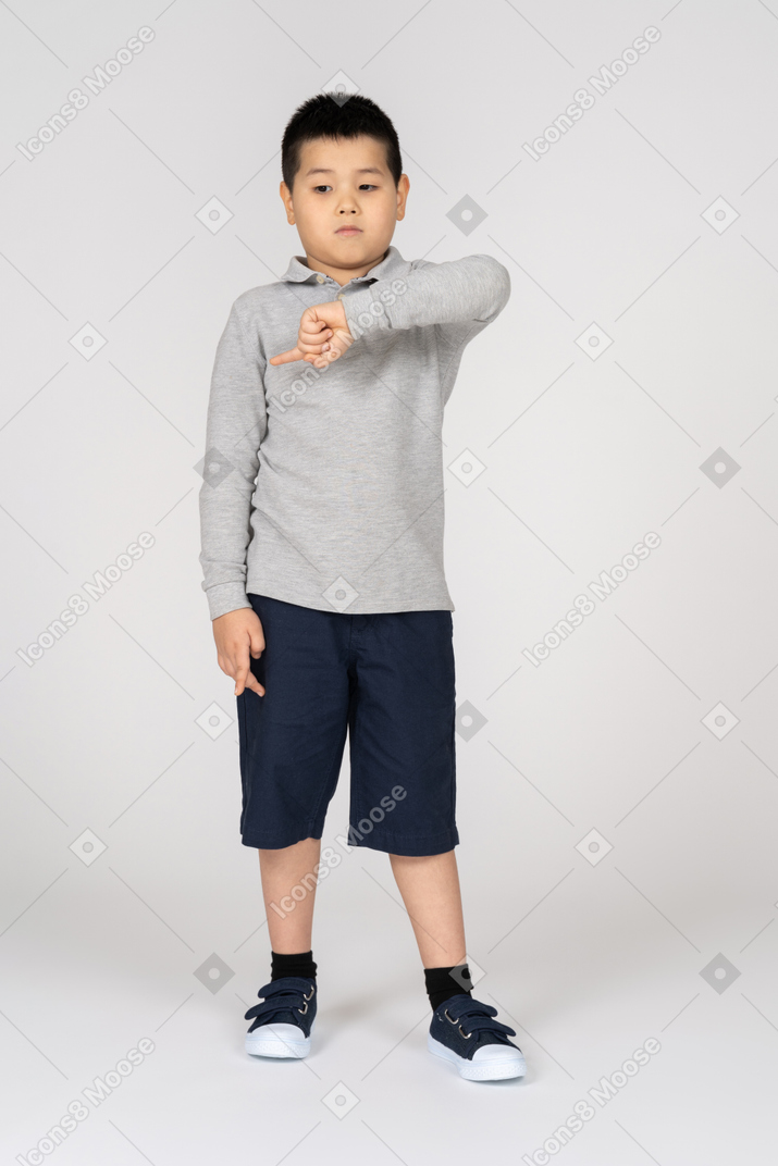 Front view of a boy pointing left