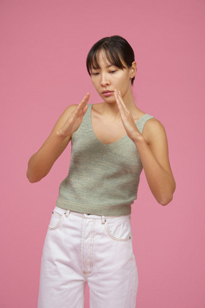 Young woman looking at her hands