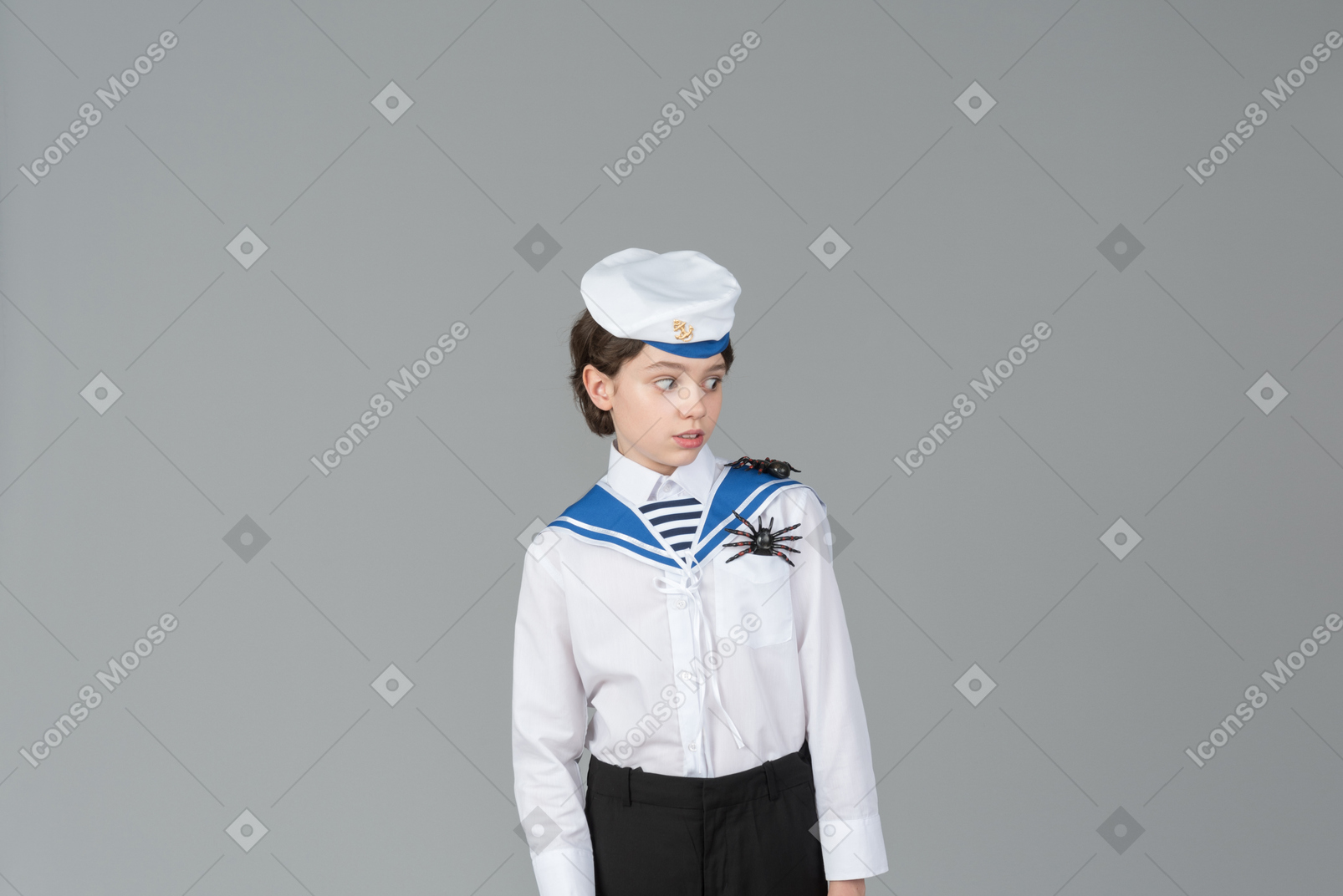 Boy in sailor's uniform scared of spiders on his shoulders
