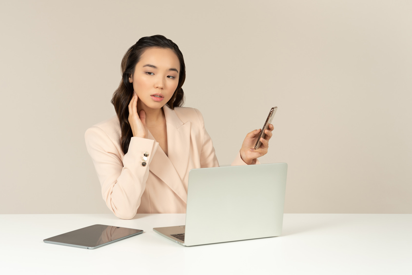 Asian female office employee checking phone