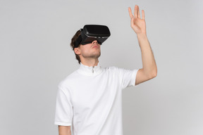 Man in virtual reality headset touching something invisible