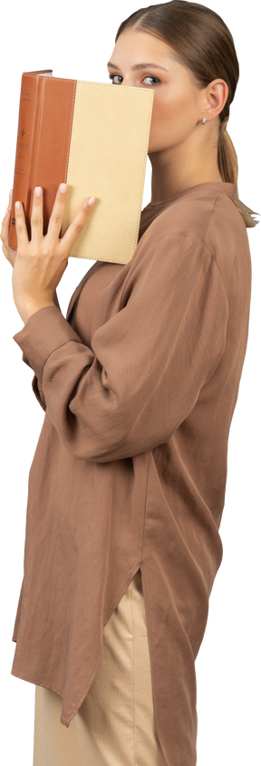 Woman covering her face with a book