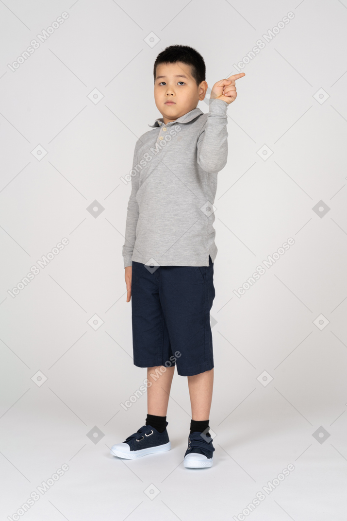 Front view of a boy pointing right