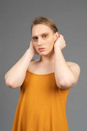 Close-up of a genderqueer person touching their head