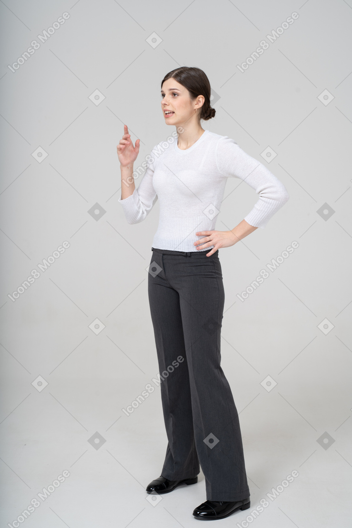 Front view of a woman in suit pointing with a finger