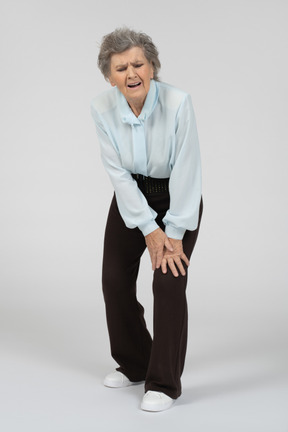 Anciana tocando su rodilla dolorida