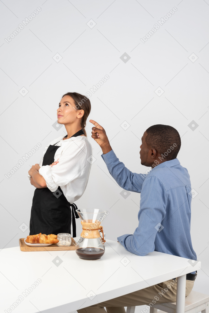 Disgruntled customer accusing an attractive waitress for bad service