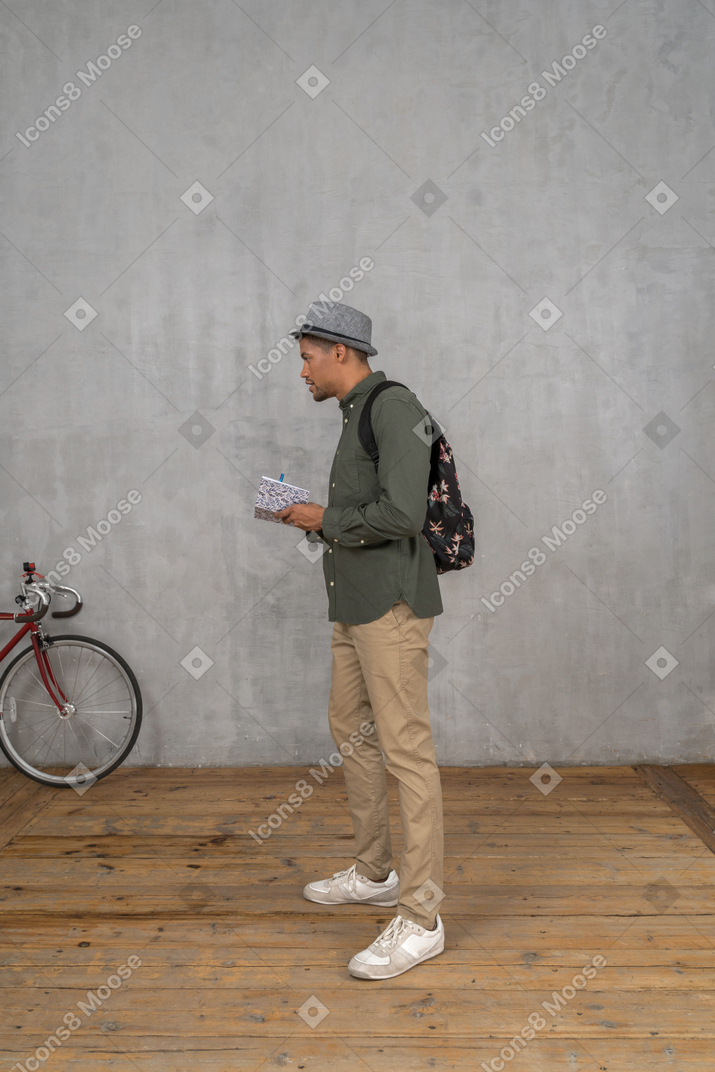 Man looking at something and taking notes