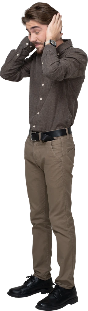 Three-quarter view of a young man in office clothing touching head