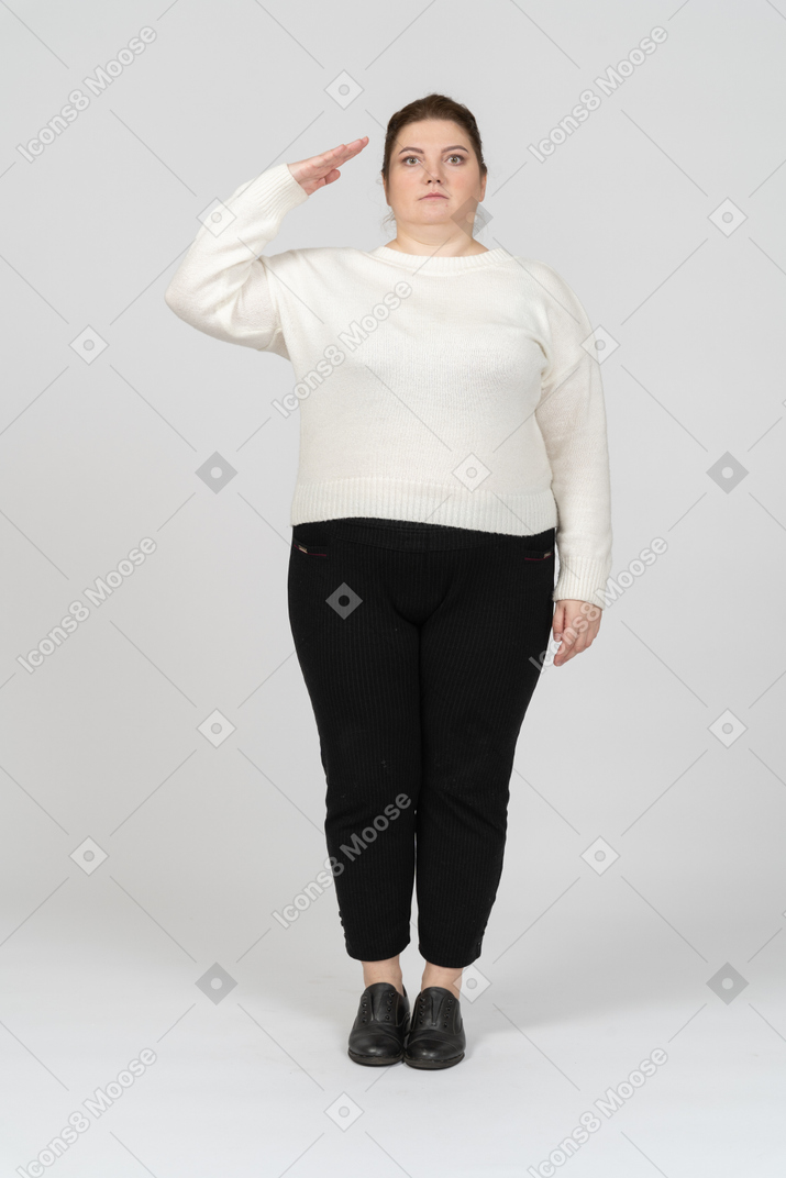 Plump woman in casual clothes saluting with hand