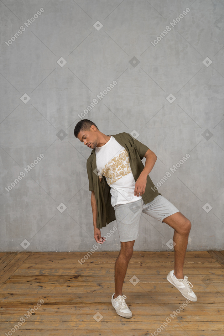 Man leaning sideways with his foot raised