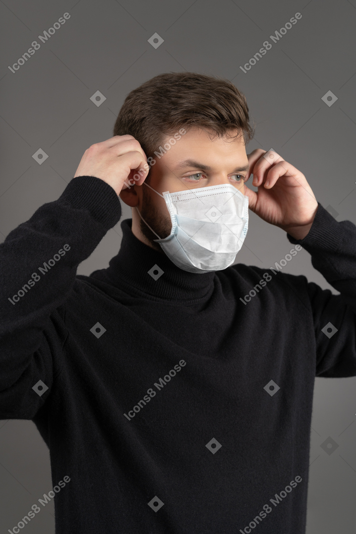Young man wearing a respiratory protection mask during coronovirus pandemic