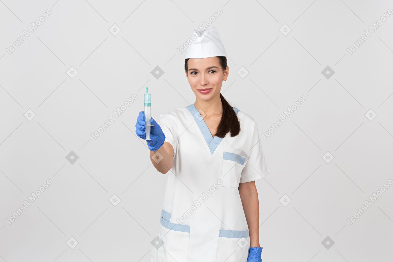 Attractive nurse demonstrating a disposable syringe