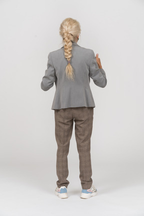 Back view of an old lady in suit