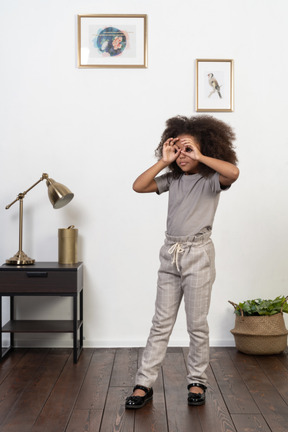 Good looking girl kid posing on the apartment background