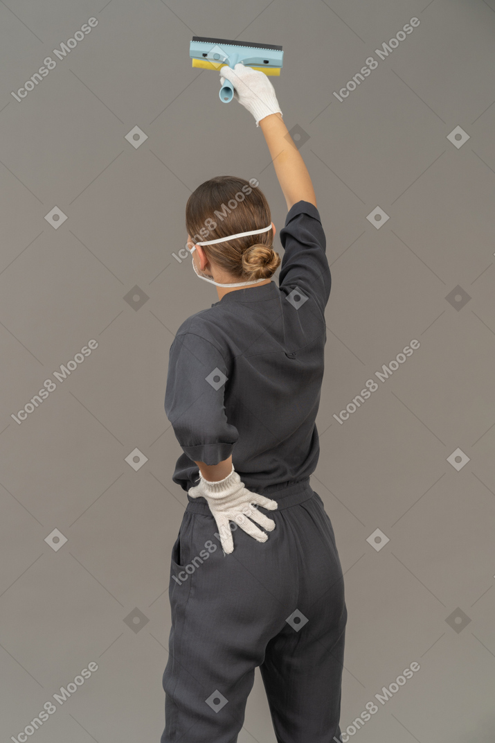 Back view of a woman with a window-cleaning tool