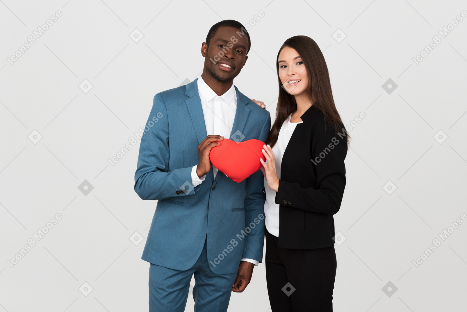 Beautiful interracial couple holding a toy heart together