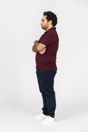 A young man standing with his arms crossed