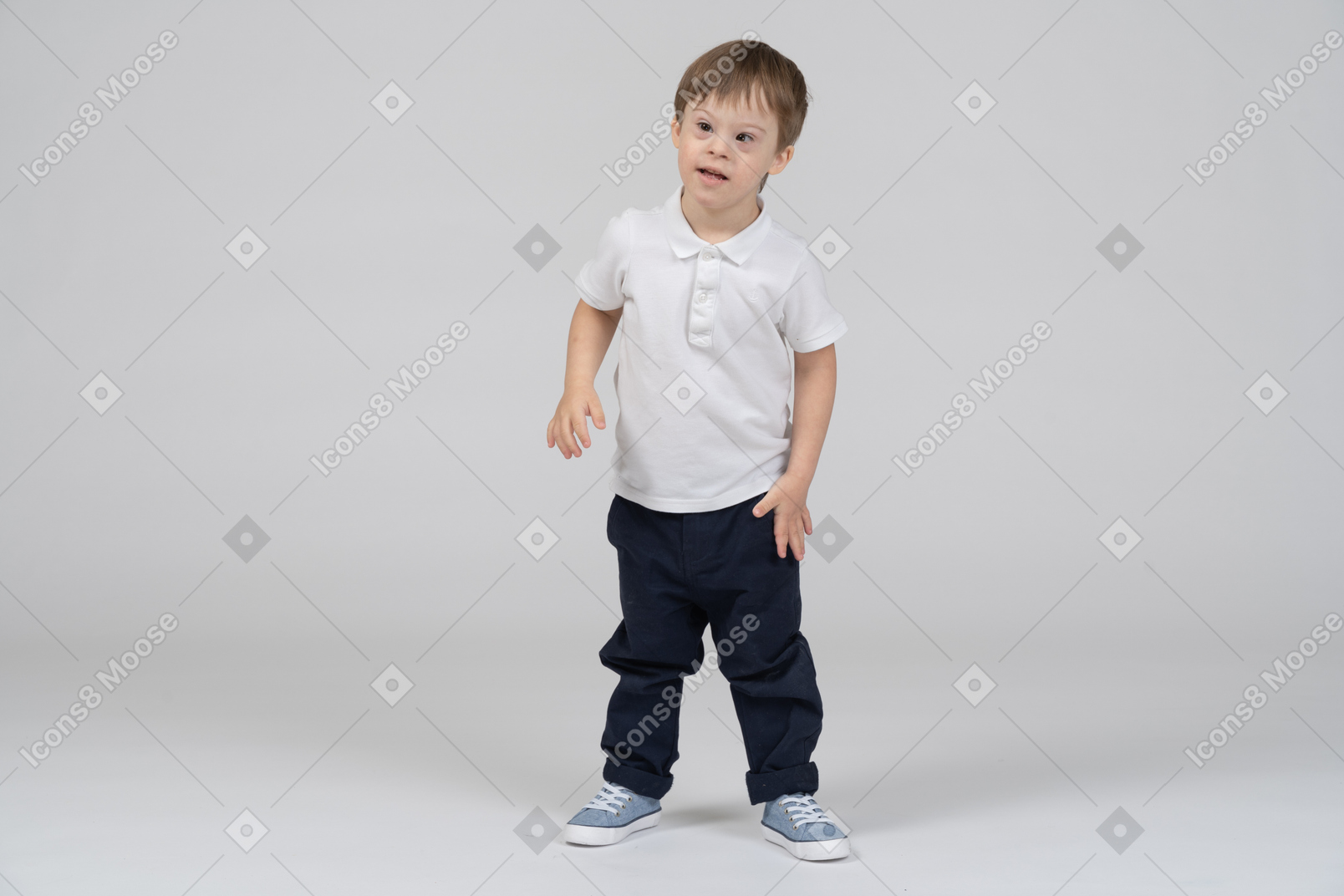 Little boy standing with arms at sides