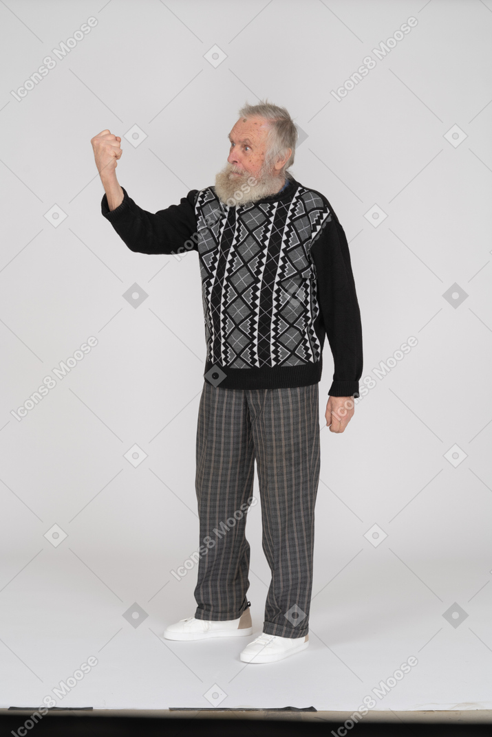 Old man clenched fist and threatening