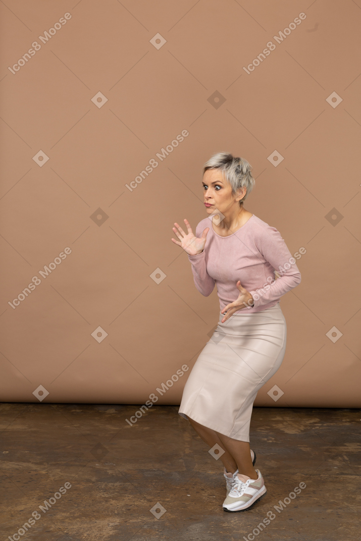 Scared woman in casual clothes posing in profile
