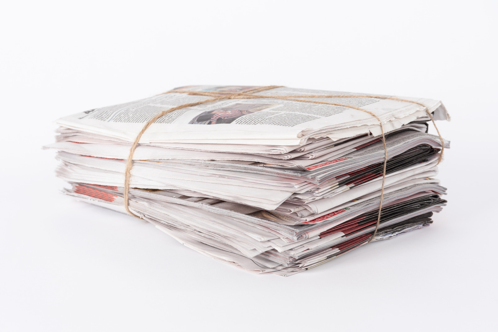 Pile of old newspapers on white background