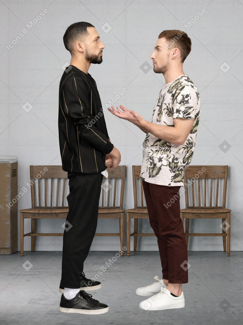 Two men talking to each other in a room
