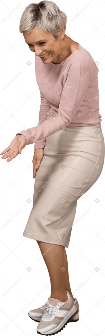 Side view of a happy woman in casual clothes showing a welcoming gesture