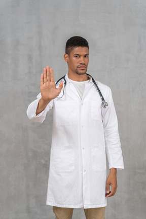 Male doctor showing stop hand