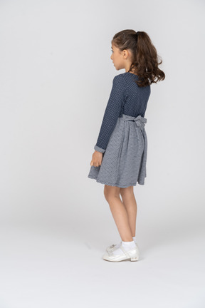 Three-quarter back view of a girl leaning back slightly
