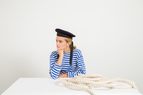 Female sailor leaning her chin on fist