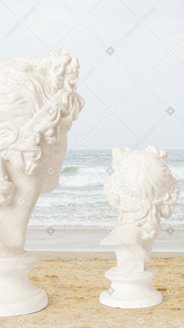 White sculptures on a sandy beach