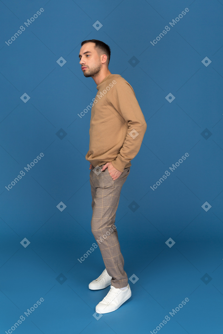 Young man standing and thinking