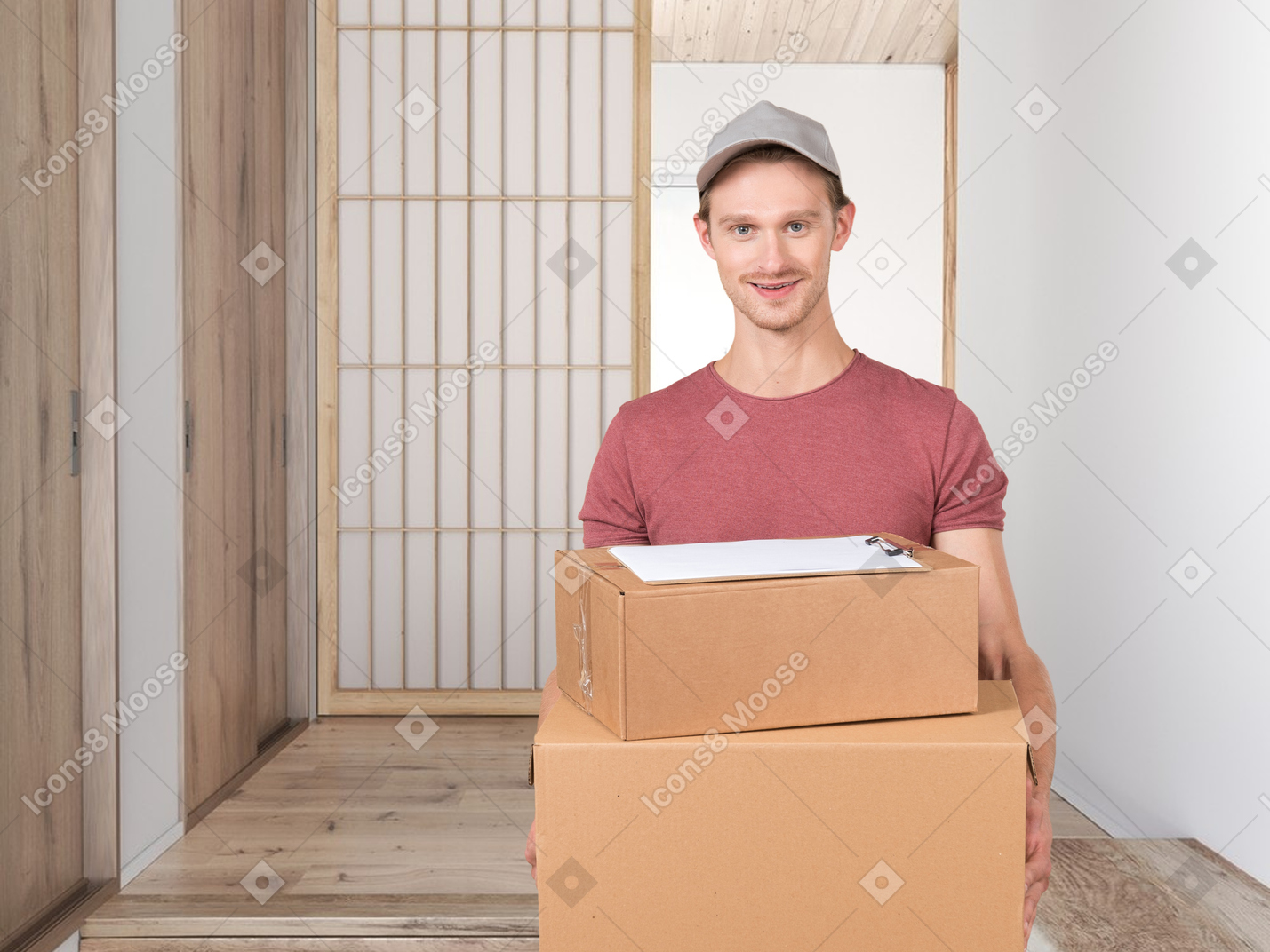 A man holding two boxes in a room