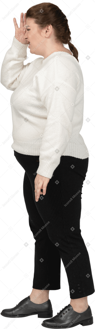 Plus size woman in casual clothes looking through fingers